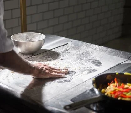 Chef&amp;#039;s Hands Kneading Bread Dough on a Floured Worktop Stock Photos
