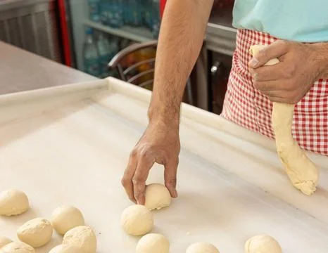 Chef&amp;#039;s Hands Kneading Bread Dough on a Floured Worktop Stock Photos