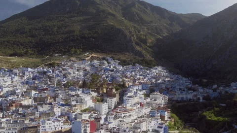Chefchaouen in Mountain Shadow Drone Pull Back Stock Footage 336570868