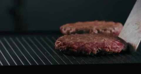 Cheff turns the cutlets on the grill several times Stock Footage 229763575