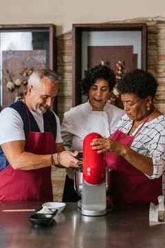 Chefs and students learning using stand mixer in cooking class Stock Photos