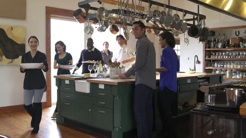 Chefs and students sitting down to a table to have a meal Stock Footage 77081858