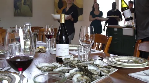 Chefs and students sitting down to a table to eat 스톡 동영상 77081864