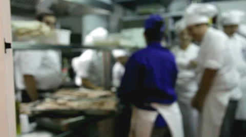 Chefs and waiters in the kitchen working and talking. Stock Footage 23535979