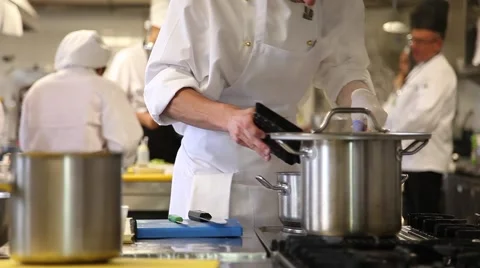 Chefs cooking in the restaurant kitchen stove, slider shot Stock Footage