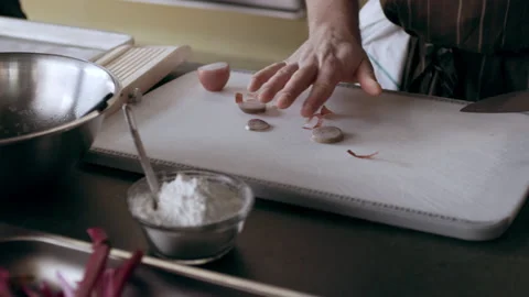 Chefs cutting and peeling small cooking onions on white cutting board in interio Stock Footage 199458852