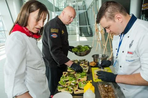 Chefs in different uniforms serving snacks on table for degustation in Lviv a Foto stock