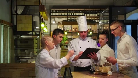 Chefs discuss the new restaurant menu. Stock Footage 147482301