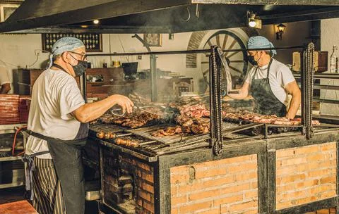 Chefs in Face Mask Using Grill Stock Photos