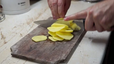 Chef's fast Hand cutting Potato, at home kitchen, chips making Stock-Footage 206064244