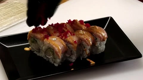 Chef's gloved hands sprinkle sushi Stock Footage 285250994