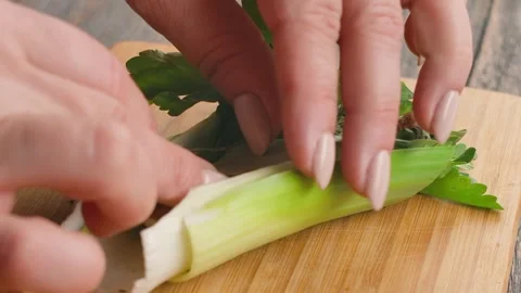 Chefs hand adding a bay leaf to a fresh bouquet garni Stock Footage 315702733