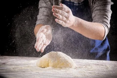 Chef's hand clapping with powder flour when kneading the dough Stock Photos