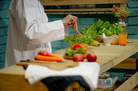 Chef's hand, cooking vegetable salad, healthy food Cooking concept Stock Illustration