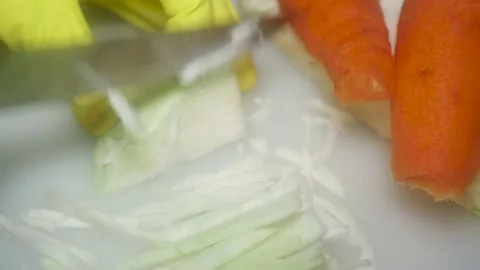 The chef's hand cuts cabbage with a knife on a white cutting board, close-up 스톡 동영상 231325830