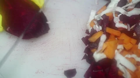 The chef's hand cuts red beets with a knife on a cutting board for cooking r 스톡 동영상 231326426