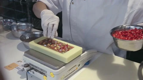 Chef's hand decorate creative chocolate with topping, slow motion Stock Footage 218195795