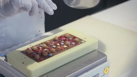 Chef's hand decorate creative chocolate with topping, slow motion Stock Footage 240511199