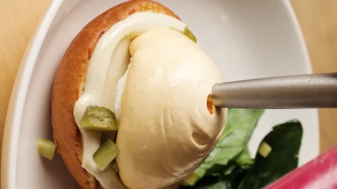 The chef's hand pours parmesan mousse Stock Footage 263730100