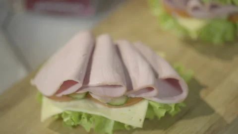 Chef's hand puts hamburger bread on beef. Macro shot, 4k Video stock 143656144