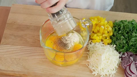 Chef's hands adding black pepper, salt and spices to glass measuring cup Stock Footage 263155946