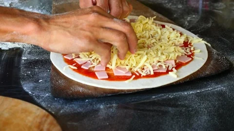 Chef's hands are laying mozzarella cheese on pizza dough Stock Footage 221737983