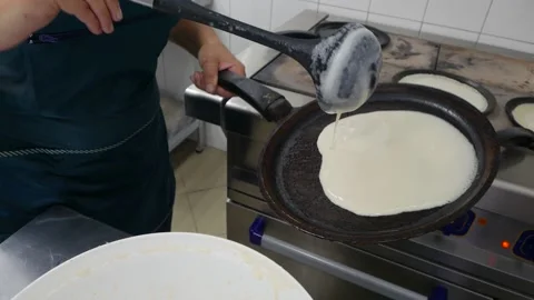 Chef's hands are preparing pancakes Stock Footage 148458848