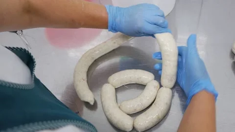Chef's hands are preparing sausages Stock Footage 148460055