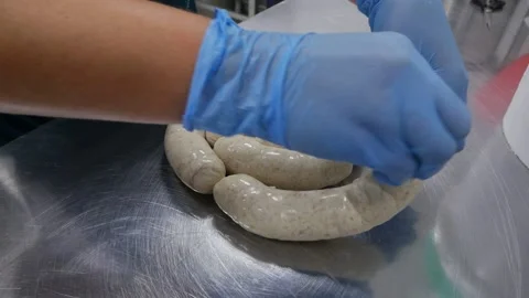 Chef's hands are preparing sausages Stock Footage 148460355