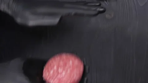 The chef's hands in black gloves form a hamburger patty. Stock Footage 234009319
