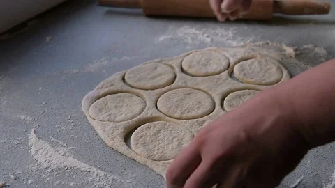 Chef's hands close-up unnecessarily remove dough from squeezed circles Stock Footage 130656762