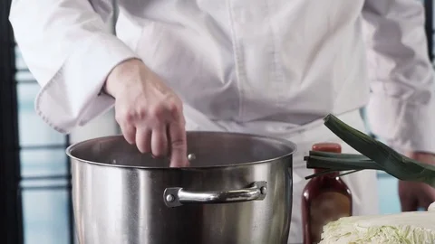 Chef's hands cooking soup, mixing with wooden spoon at modern kitchen Video stock 73213985