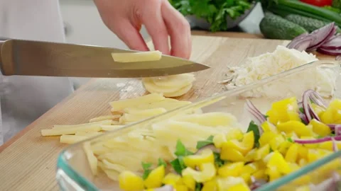 Chef's hands cut potato slices into cubes, prepare healthy food Stock Footage 263155686