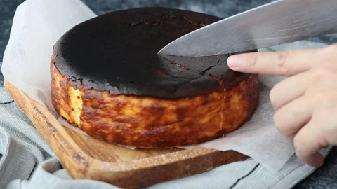 Chef's Hands cutting Basque Cheese Cake. Stock Footage 127881932