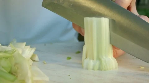 Chefs hands cutting a fresh green celery leaf. 스톡 동영상 80114837