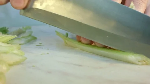 Chefs hands cutting a fresh green celery leaf. 스톡 동영상 80115636