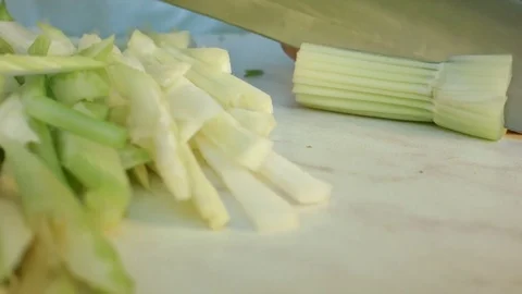Chefs hands cutting a fresh green celery leaf. Video stock 80115821