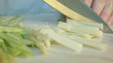 Chefs hands cutting a fresh green celery leaf. Vídeos de archivo 80180475