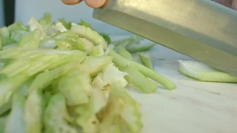 Chefs hands cutting a fresh green celery leaf. 스톡 동영상 80180479