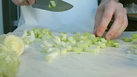 Chefs hands cutting a fresh green celery leaf. Stock-Footage 80254682