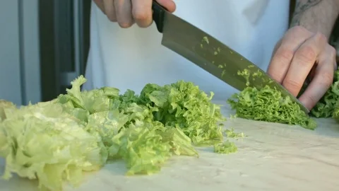 Chefs hands cutting a fresh green celery leaf. Video stock 80255482
