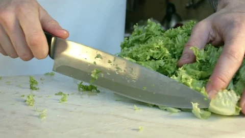 Chefs hands cutting a fresh green salad leaf. Stock-Footage 80255543