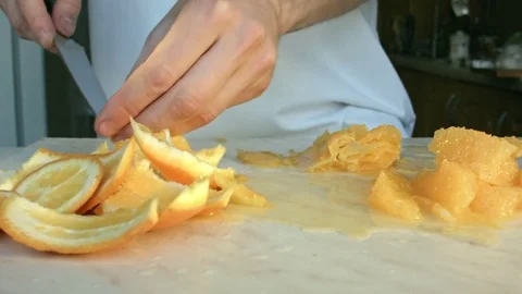 Chefs hands cutting a fresh orange. Vídeos de archivo 80186865