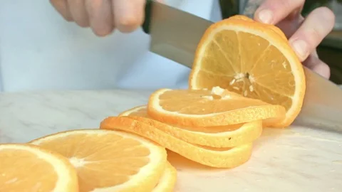 Chefs hands cutting a fresh orange. Stock-Footage 80471512