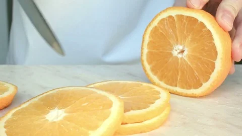 Chefs hands cutting a fresh orange. 動画素材 80471535