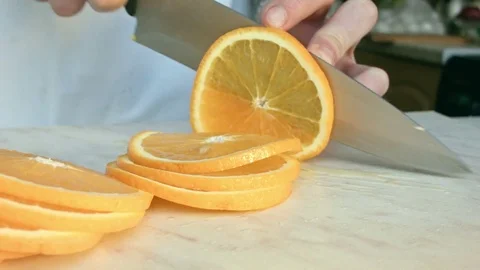 Chefs hands cutting a fresh orange. Stock Footage 80471547