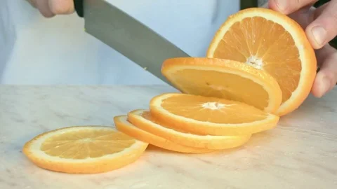 Chefs hands cutting a fresh orange. Stock Footage 80471548