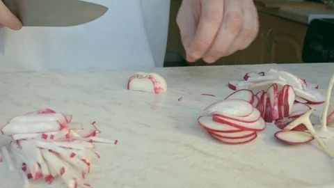 Chefs hands cutting a fresh radish. Stock Footage 80074131