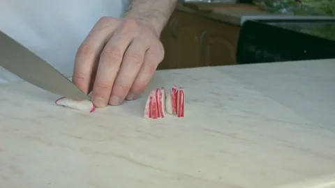 Chefs hands cutting a fresh radish. Stock Footage 80074323