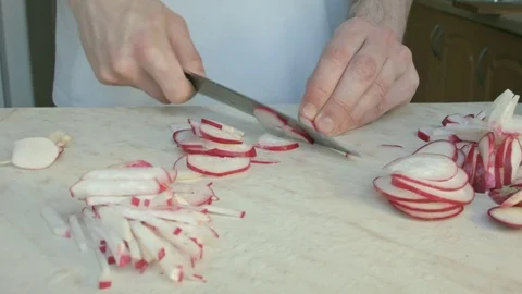 Chefs hands cutting a fresh radish. Video stock 80074330